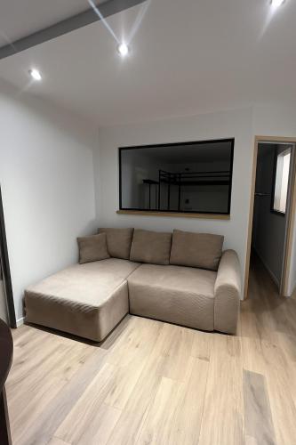 a living room with a couch and a flat screen tv at Appartement 1 Chambre in Les Houches