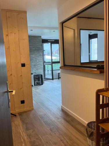 a room with a hallway with a mirror and a door at Appartement 1 Chambre in Les Houches