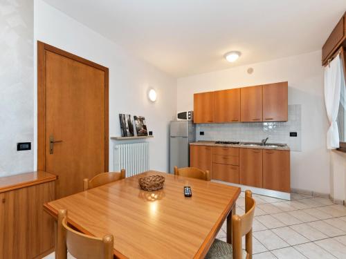ラツィーゼにあるHoliday apartment near the lake, shared swimming poolのキッチン(木製ダイニングルーム、テーブル、椅子付)
