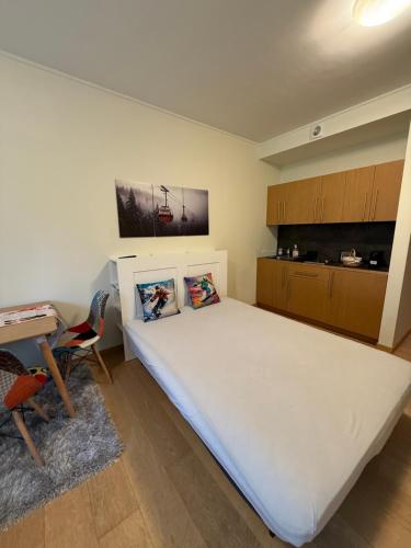 a bedroom with a large white bed and a desk at Private Studio 4 pax in Euphoria Club in Borovets