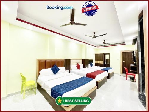 a hotel room with two beds and a desk at Hotel Premium LAXMIVILLAS ! Varanasi, Near Kashi Vishwanath Temple And Railway station, Fully Air conditioned & Spacious Room - Prime Location wifi- Lift and Room Service Facilities, BEST HOTEL IN VARANASI in Varanasi
