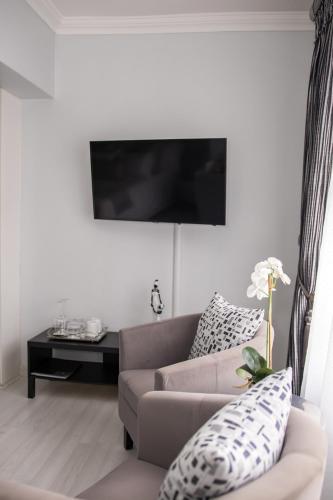 a living room with a couch and a table at Augusta Palms in Centurion