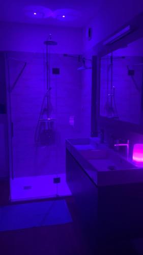 a bathroom with two sinks and purple lighting at Lo Spazio dell'Anima 