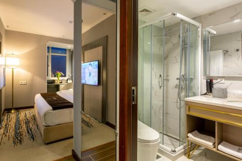 a bathroom with a shower and a toilet and a sink at Zarafshon Hotel Bukhara in Bukhara