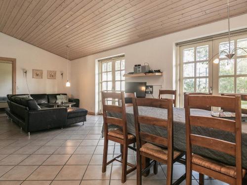 a living room with a table and chairs and a couch at 12 person holiday home in Hals in Hals