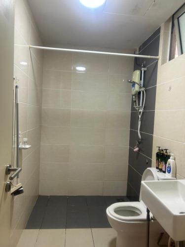 a bathroom with a toilet and a sink at Lovely Luxury Poolview in Kajang