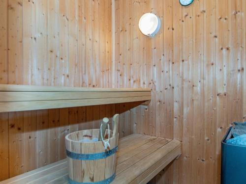 a wooden sauna with a wooden tub with scissors in it at 12 person holiday home in Aabenraa-By Traum in Loddenhøj