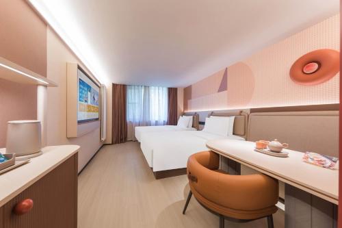 Ένα ή περισσότερα κρεβάτια σε δωμάτιο στο Orange Hotel Beijing West Railway Station South Square