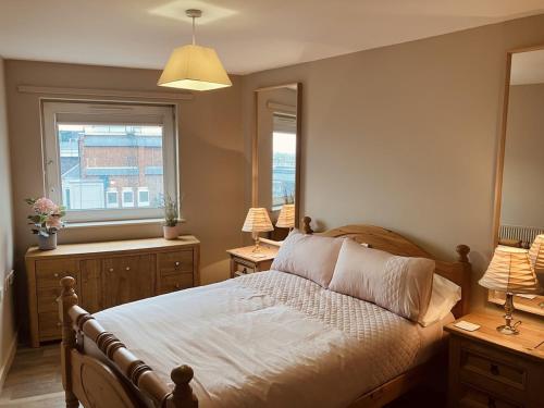 a bedroom with a bed and two lamps and a window at Central, Close to Theatre & Cruise Port, with free parking space! in Southampton