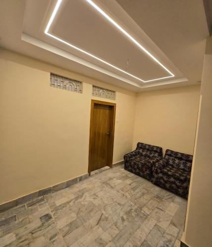 a living room with a couch and a door at Hotel Premium RUDRA GUEST HOUSE ! Varanasi, Near Kashi Vishwanath Temple And Ganga Ghat, Fully Air conditioned & Spacious Room - Prime Location BEST HOTEL IN VARANASI in Varanasi