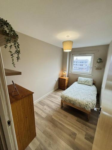 a small bedroom with a bed and a window at Central, Close to Theatre & Cruise Port, with free parking space! in Southampton