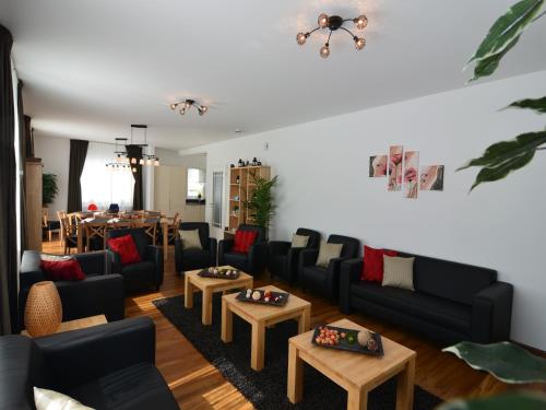 a living room with couches and tables and a dining room at Moderne Villa in Medebach Küstelberg in Medebach