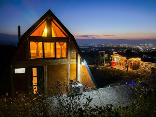 a house on a hill with the lights on at Old Chalet in Iaşi