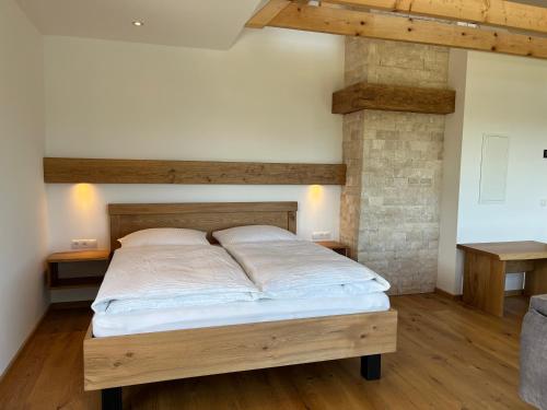 a bedroom with a bed with a wooden bed frame at Weinloft Gamlitz in Gamlitz