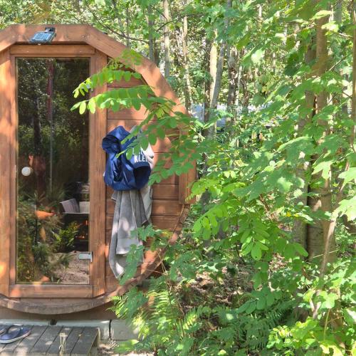 a wooden shed with a bag in it at Apartament nad jeziorem Strykowskim in Sapowice