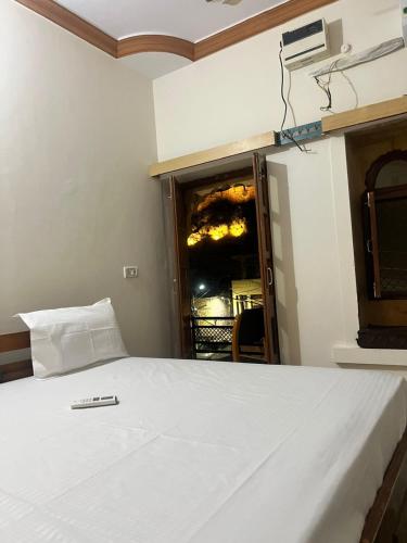 a bed with a remote control sitting on top of it at Golden villa in Jaisalmer