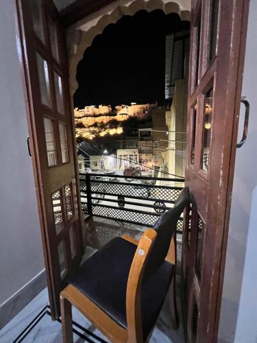 a chair in an open door with a view at Golden villa in Jaisalmer