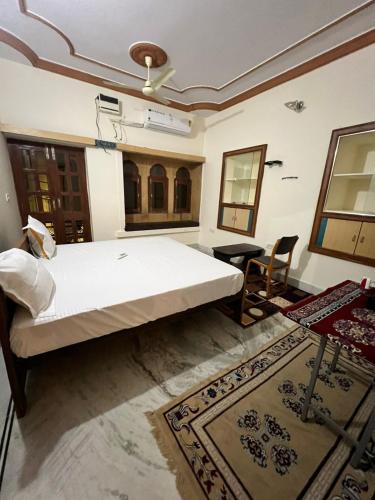 a bedroom with a large bed and a table and chairs at Golden villa in Jaisalmer