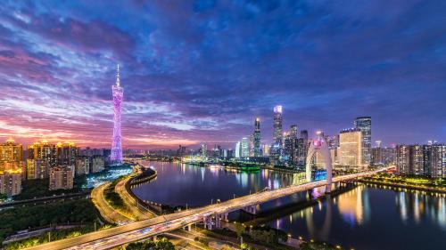 a city skyline at night with a river and a bridge at Yoo Man Joo City View Hotel - Guangzhou Canton Tower Pazhou Convention and Exhibition Center Store - Canton Fair Exclusive in Guangzhou