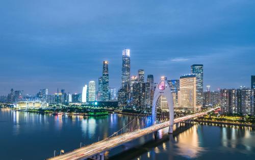a view of a city with a bridge over the water at Yoo Man Joo City View Hotel - Guangzhou Canton Tower Pazhou Convention and Exhibition Center Store - Canton Fair Exclusive in Guangzhou