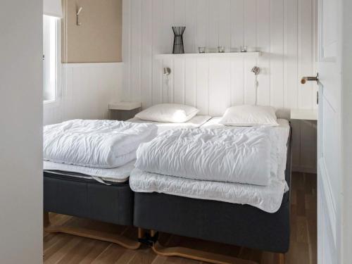 two beds in a room with white sheets and pillows at 6 person holiday home in Kopparberg in Kopparberg