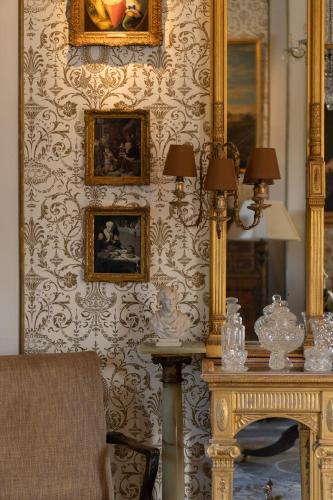 a room with a mirror and a table with a fireplace at Cabra Castle Hotel in Kingscourt
