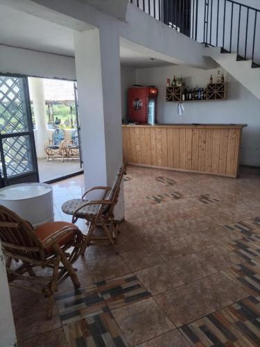 a living room with two chairs and a table at CRESCENT BEACH HOTEL And RESTAURANT in Kisumu