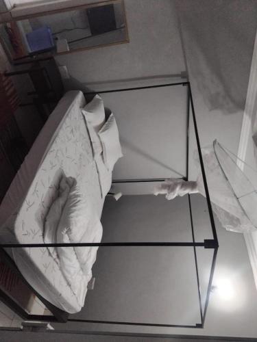 a glass table with a bed in a room at CRESCENT BEACH HOTEL And RESTAURANT in Kisumu