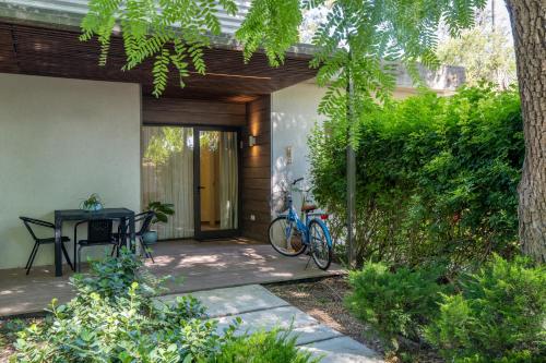 a patio with a table and two bikes on it at Kibbutz Kfar Masaryk Country Lodging in Kefar-Massariq