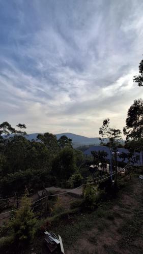 a view of a hill with trees and a sky at restogreen diva in Suryanelli