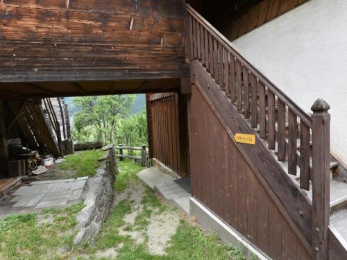 an entrance to a building with a wooden fence at Cozy Stay near Aletsch in Grengiols