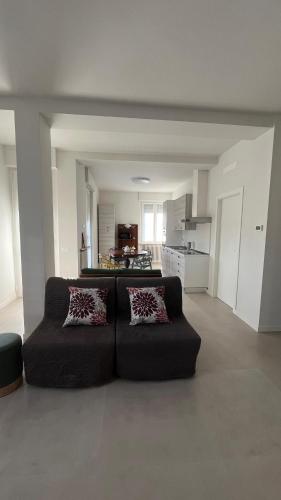 a living room with a couch and a kitchen at Brianza Verde 25 in Bernareggio
