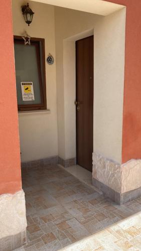 an empty room with a door and a tile floor at Stanza Luna in Ragalna