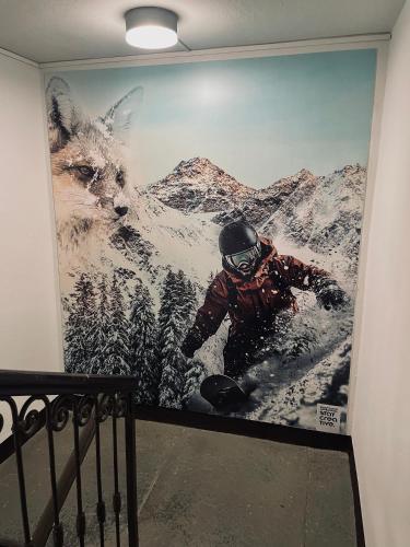 a person riding a snowboard in a mural on a wall at Alpine Hut in Pont-Saint-Martin