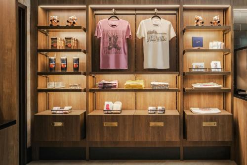 a dressing room with shelves and shirts on display at Sheraton Music City Nashville Airport in Nashville