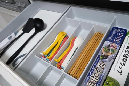 a lunch box with utensils and a book at VILLA fantasia Okinawa Kitanakagusuku in Kitanakagusuku