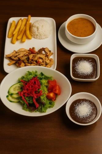 a table with plates of food and bowls of dip at Cip Hotel & Spa - İstanbul Bakırköy City Center in Istanbul