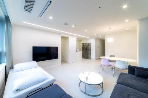 a living room with a couch and a table at Hotel Modak Namdaemun in Seoul