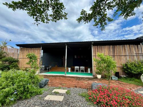 a house with a pool in the yard at 夏日禾風庭園包棟 in Checheng