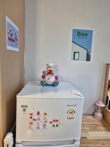 a snow man sitting on top of a refrigerator at Hongdae Home Sweet Home in Seoul