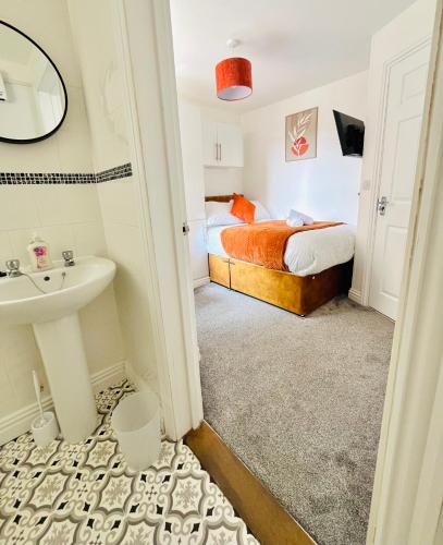 a small bathroom with a bed and a sink at Cleveland Road Ensuites in Portsmouth