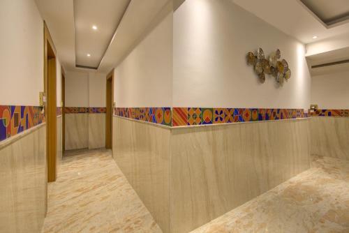 a hallway with wooden walls and a clock on the wall at AIRPORT HOTEL ELEVATE NEAR Delhi Airport WITH- Free Airport PICKUP in New Delhi