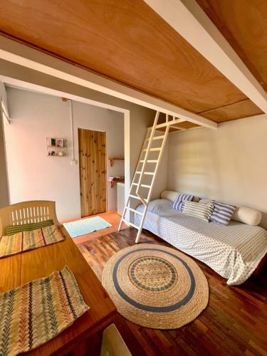 a room with a bunk bed and a ladder at Ti Lakaz Kreol 2 in Pereybere