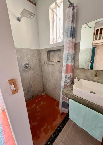 a bathroom with a pool of water in the floor at Ti Lakaz Kreol 2 in Pereybere
