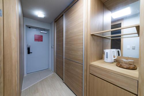 a walk in closet with a white coffee maker in it at Hotel Modak Namdaemun in Seoul