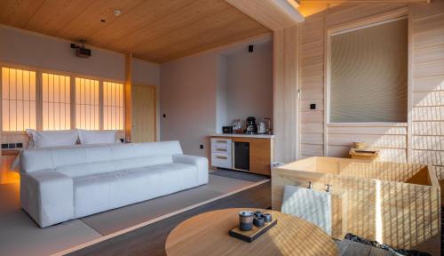 a living room with a white couch and a table at 北京一瓢客栈 Beijing YiPiao Inn in Beijing