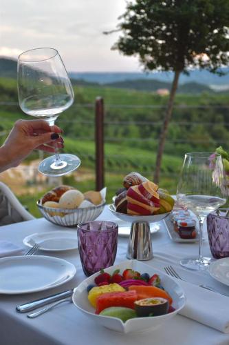 a table with plates of food and a glass of wine at Boutique Hotel Municipio 1815 in Valdobbiadene
