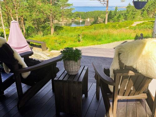 a porch with two chairs and a table with a plant at 6 person holiday home in Aure-By Traum in Aure