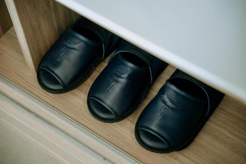 a couple of black slippers sitting in a drawer at BlueSotel Krabi AoNang Beach in Ao Nang Beach
