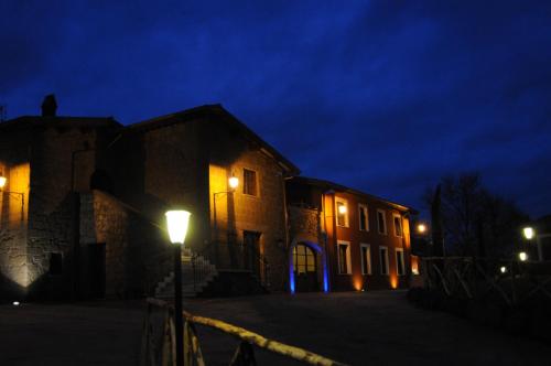a building with a street light at night at Agriturismo Podere Del Lepre in San Quirico